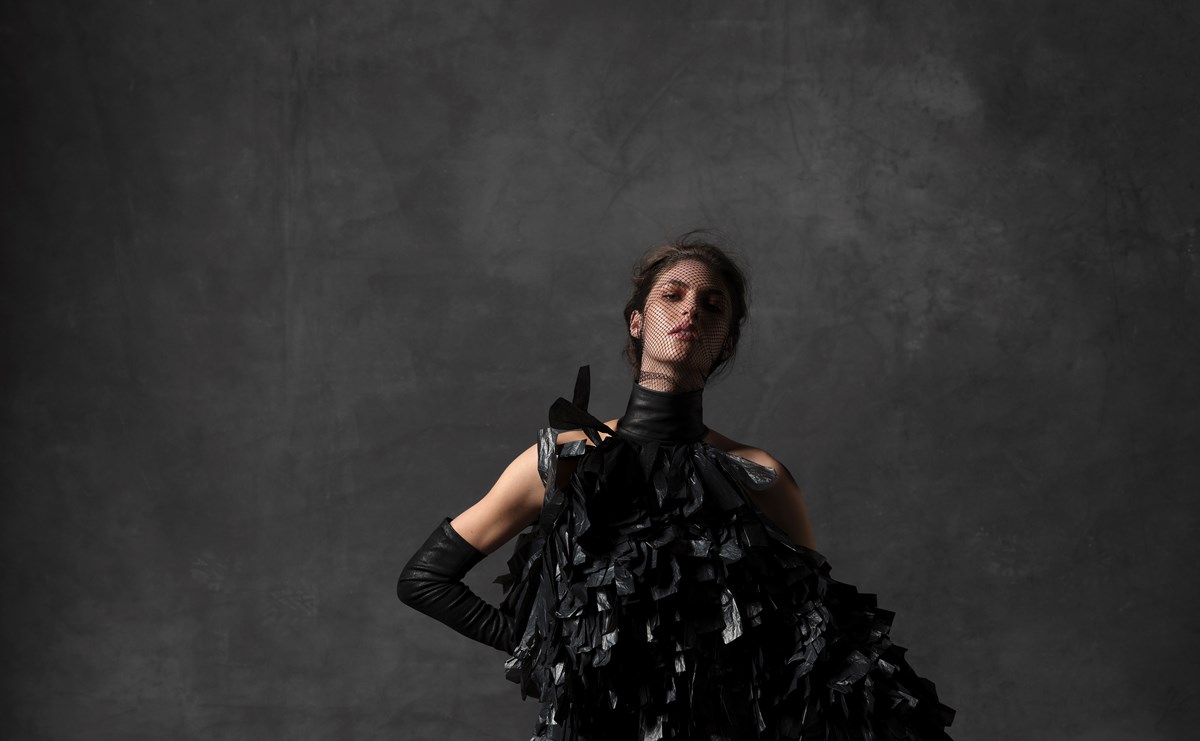 A model poses in Gareth Pugh's dress and headpiece, made from bin bags.