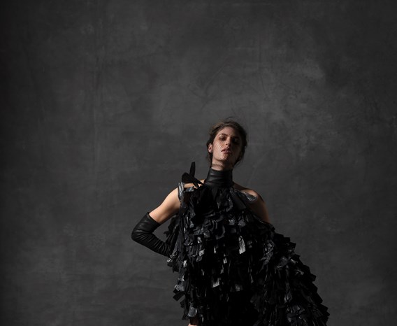 A model poses in Gareth Pugh's dress and headpiece, made from bin bags.