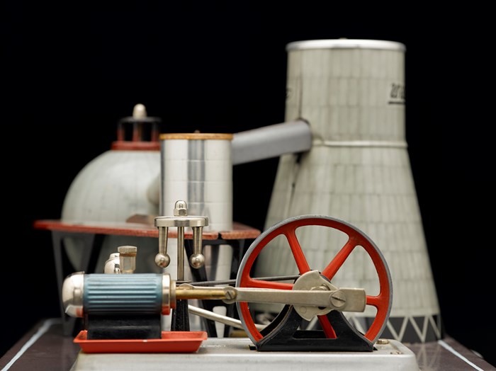 Model of a minature power station in red and metalics.