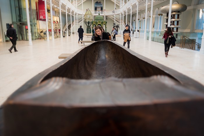 A visitor looking at the 12 foot long feast bowl in the Grand Gallery