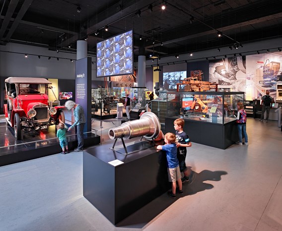 A number of visitors play with interactives and enjoy objects across the Making It gallery.