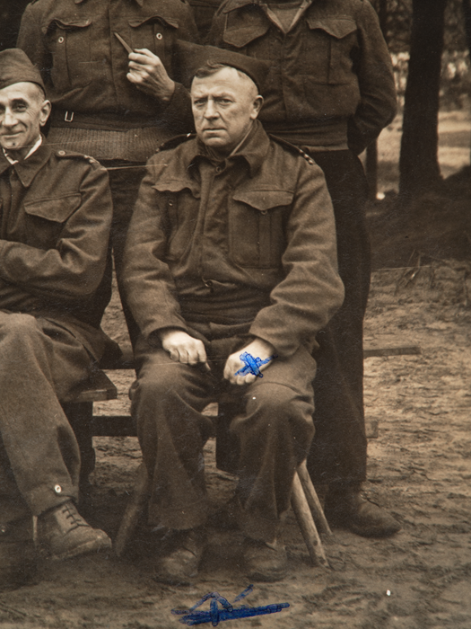 Photograph of Gordon Rose, sitting on a bench in Merchant Navy uniform.