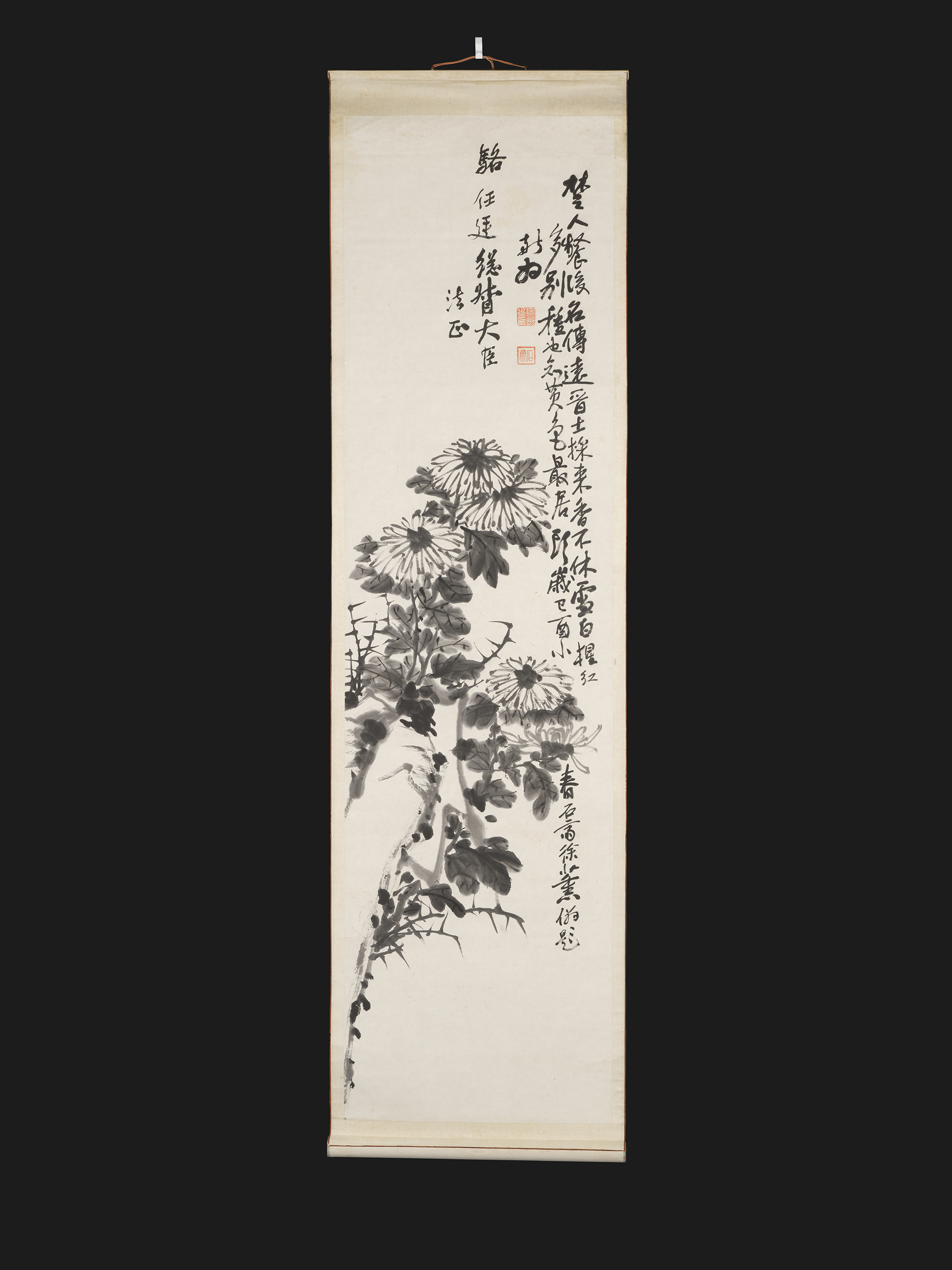 A hanging scroll painting, depicting a rock and chrysanthemums.