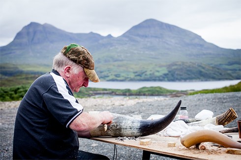 With the stunning backdrop of the Sutherland mountains behind him, Johnny is working on our specially commissioned African ankole horn recreation, based on the proportions of the Bullion Man stone. One of the smaller amber coloured highland cow horn recreations also sits waiting to be finished.
