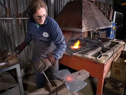 Working the hot metal to create a new bell.