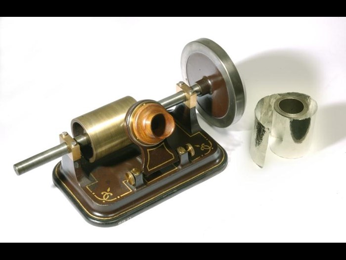 Edison foil phonograph with large flywheel, cast iron base, adjustable diaphragm and steel point for recording sound. It cost 10 guineas in 1878, and was made by the London Stereoscopic Company, England, c. 1878.