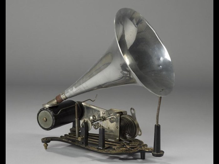 Skeleton phonograph with cast iron base with zinc cylinder driven by a cord from a small clockwork mechanism with governor, and an aluminium horn with reproducer marked Skylark.