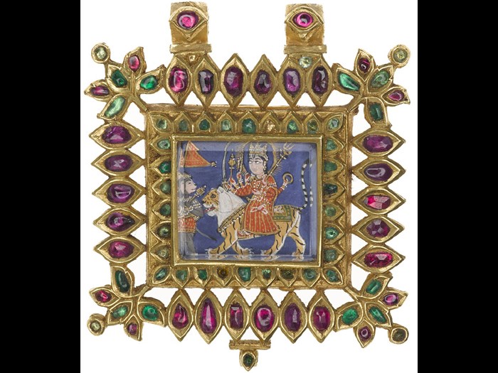 Gold pendant with rubies and emeralds; in the centre a depiction of the Hindu goddess Devi seated on a lion and preceded by the god Hanuman: Northern India, probably Rajasthan, 1800-1850, formerly in the possession of Maharaja Duleep Singh. 