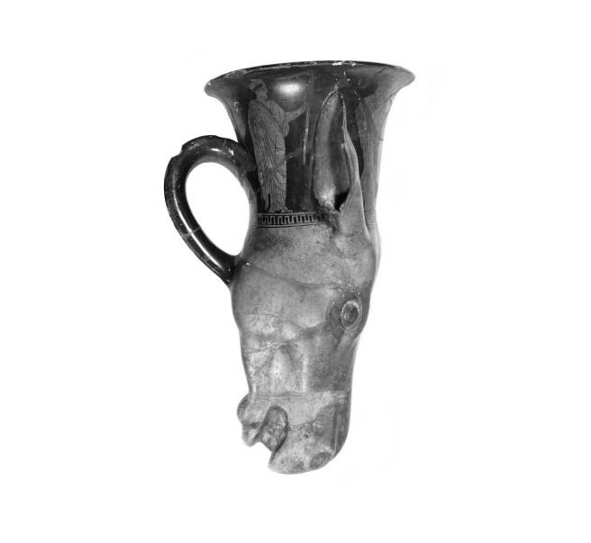 Rhyton of earthenware, in form of an ass's head with handle, covered with black and grey glazes and decorated with four standing figures, broken and repaired.