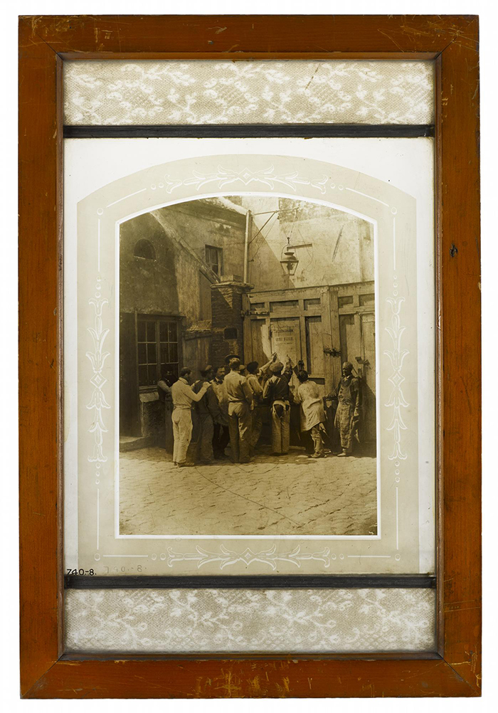 Photograph burnt in on glass, a group of workmen, Paris 1858.