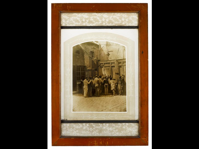 Photograph burnt in on glass, a group of workmen, Paris 1858.