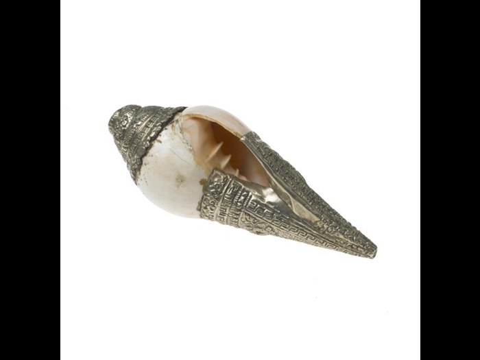 Dung dkar (trumpet), conch shell with decorated silver mounts. Dung dkar are played in Tibetan Buddhist ceremonies. India, early-mid 20th century.
