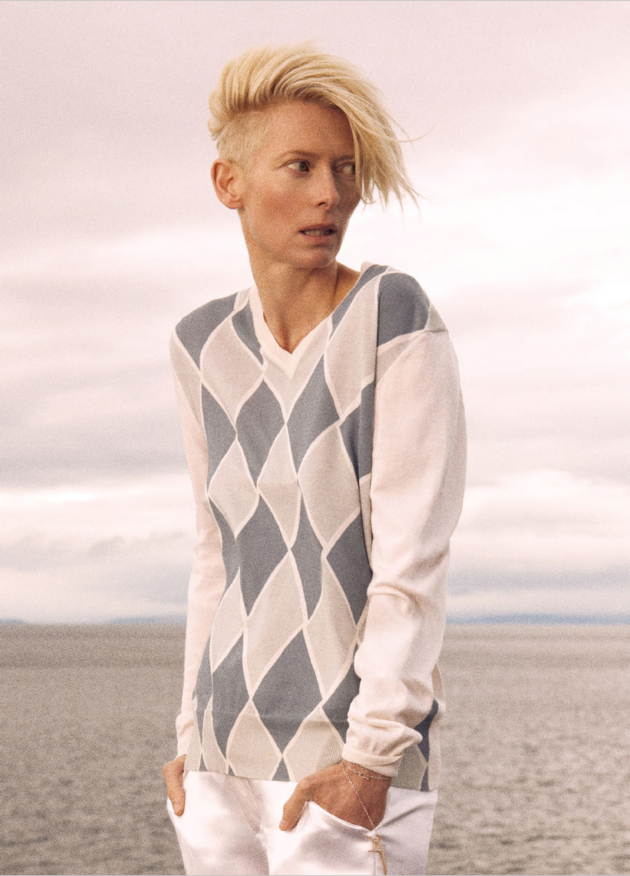 Tilda Swinton wearing an argyle pattern sweater, photographed by Ryan McGinley in 2010.