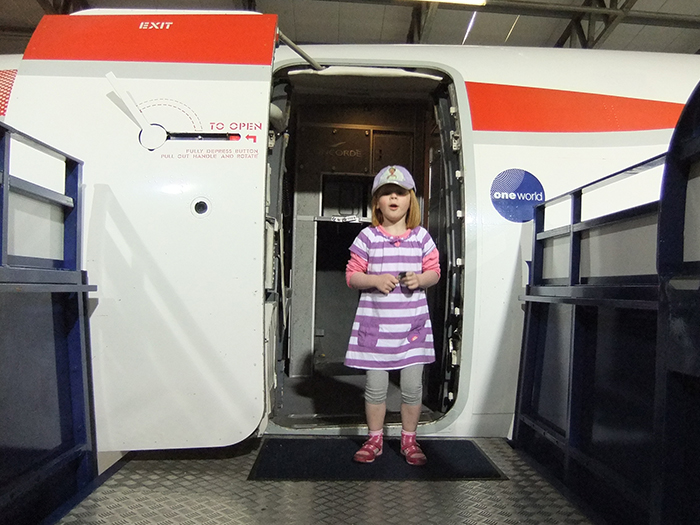 Child stands in front of the open door of Concorde