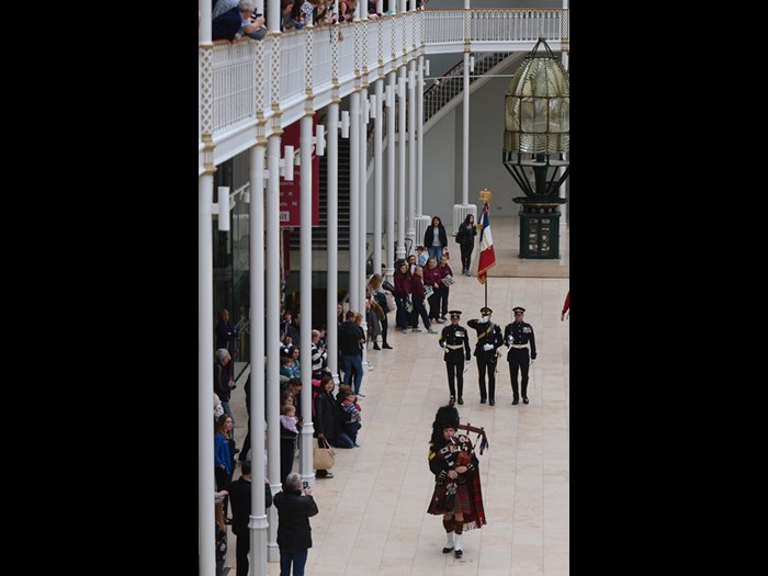 Soldiers of the Royal Scots Dragoon Guards marching the replica standard and eagle through the Grand Gallery. 