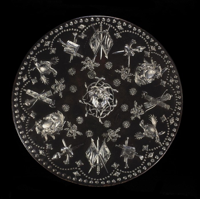 Highly decorated Jacobite round shield or targe with silver mounts. Medusa's face is in the centre surrounded by quivers, flags, swords and guns.