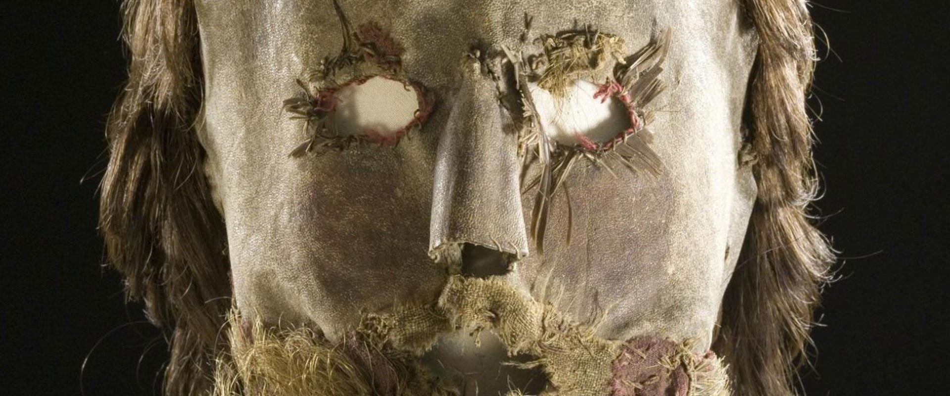 Closeup of Alexander Peden's mask. Resembles a human decaying human face with eye holes and real light brown hair with beard. 