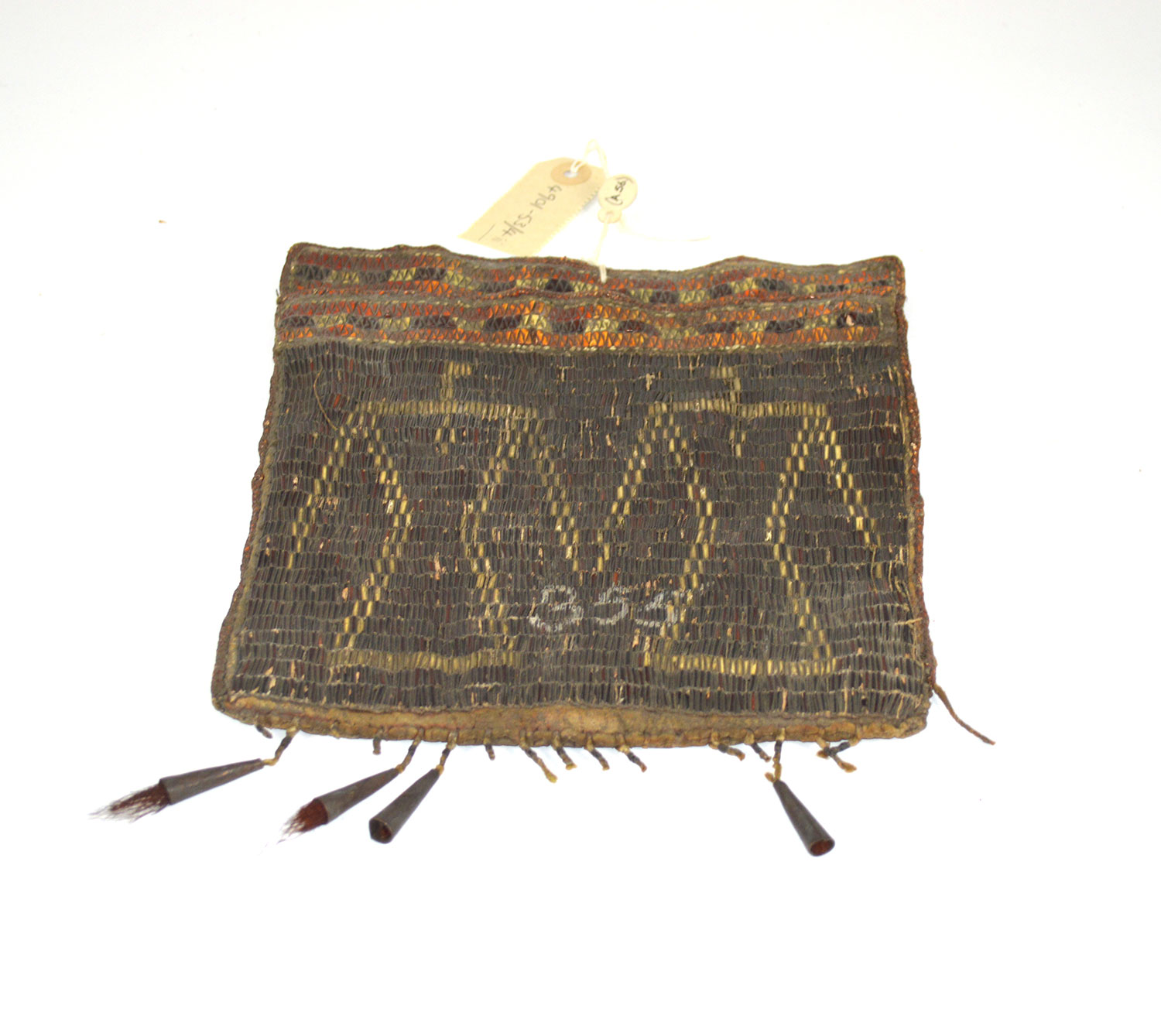 Algonquian bag decorated with porcupine quillwork of double thunderbird design, late 18th-mid 19th century. The number 355 may relate to numbers used in the model room, which comprised of the earliest collections in what is now the Royal Engineers Museum. This bag was mistakenly associated with South African collections until the 1990s. © Royal Engineers Museum, Library and Archive.