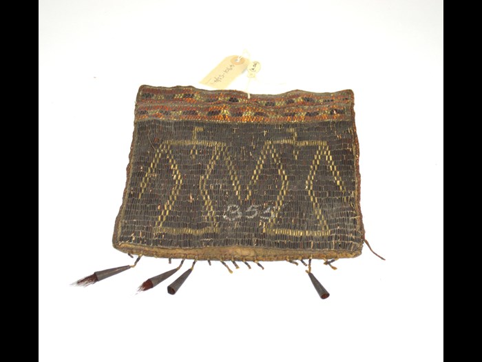 Algonquian bag decorated with porcupine quillwork of double thunderbird design, late 18th-mid 19th century. The number 355 may relate to numbers used in the model room, which comprised of the earliest collections in what is now the Royal Engineers Museum. This bag was mistakenly associated with South African collections until the 1990s. © Royal Engineers Museum, Library and Archive.