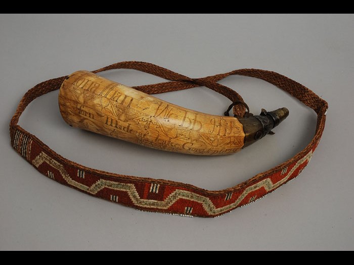 Powder horn inscribed with names James Cameron of 42nd Highland Regiment (Black Watch) and Jonathan Webb, dated 1758. The strap, adapted from a burden strap (or tumpline) of vegetal fibre and moosehair false embroidery is of the type known to be supplied to the regiment for tying blanket roles. Burden straps are Iroquois and Huron in manufacture. (M.1931.581)