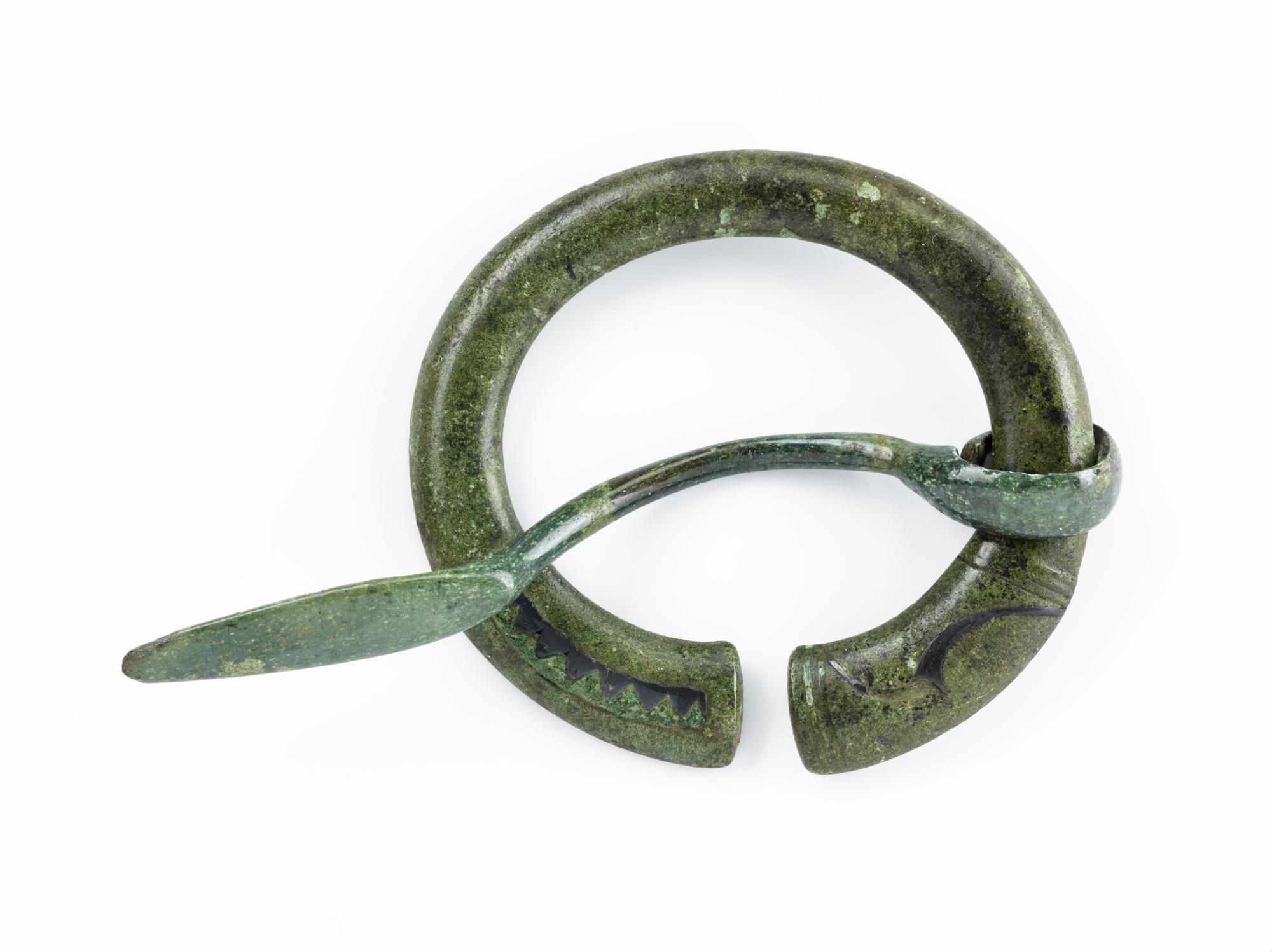 Image of Penannular brooch of bronze, with terminals decorated with blue enamel and silver inlay, from the Roman site at Newstead, late 1st or 2nd century AD © National Museums Scotland