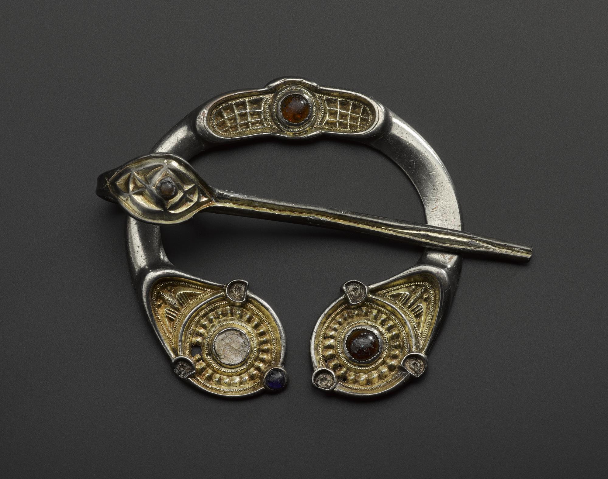 Image of Silver penannular brooch with gilt panels and glass insets, from Aldclune, Perthshire, 750 - 900 © National Museums Scotland