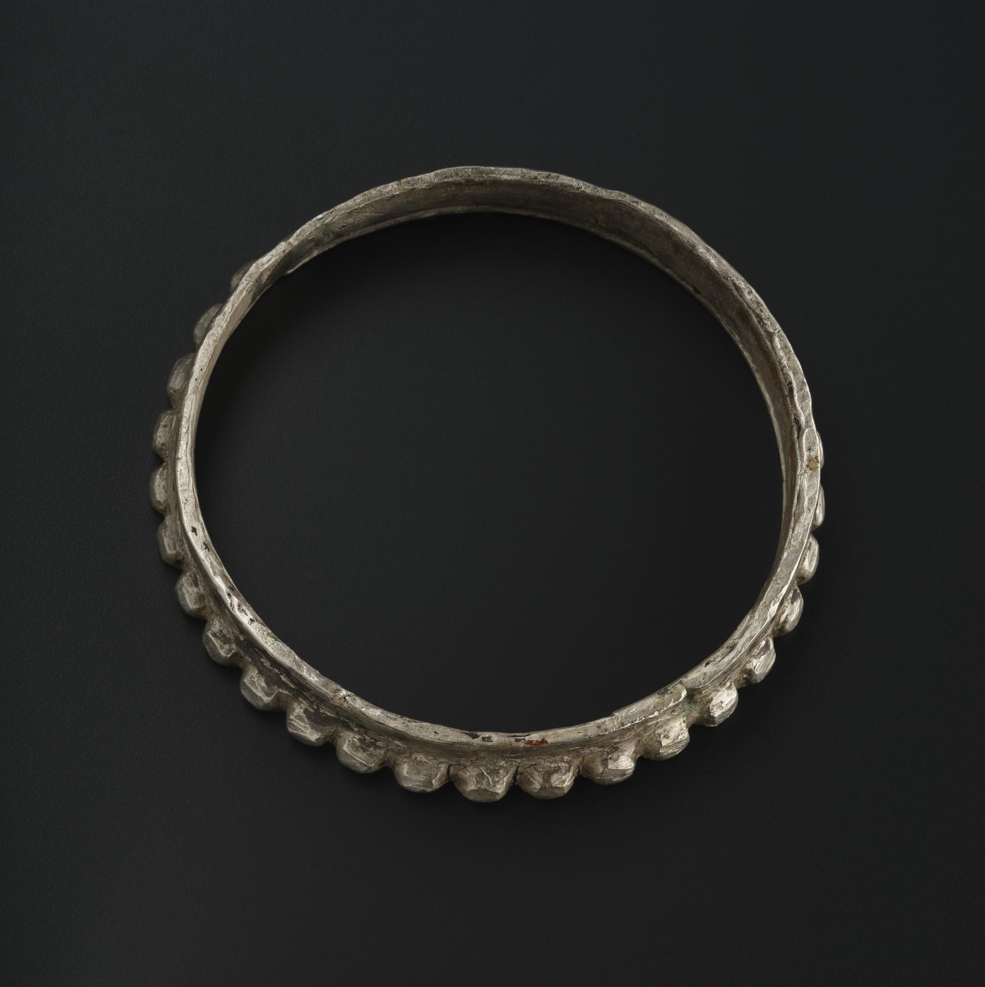 Image of Ring-shaped silver mount with border of rude pellets for the mouth of a vessel, from Traprain Law © National Museums Scotland