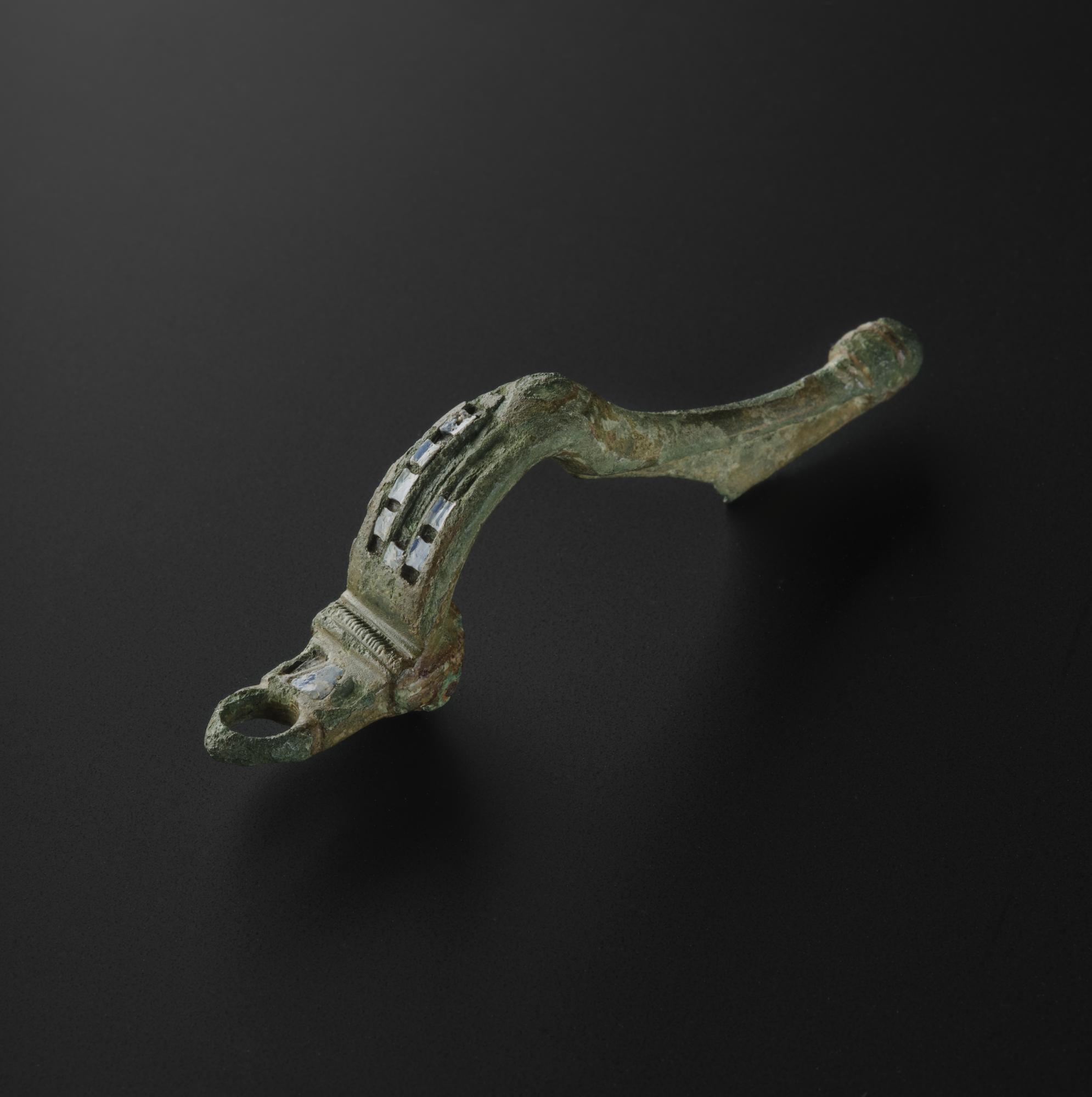 Image of Bar brooch of bronze with remains of blue enamel, found near Peebles, from North East England, 100 - 200 AD © National Museums Scotland