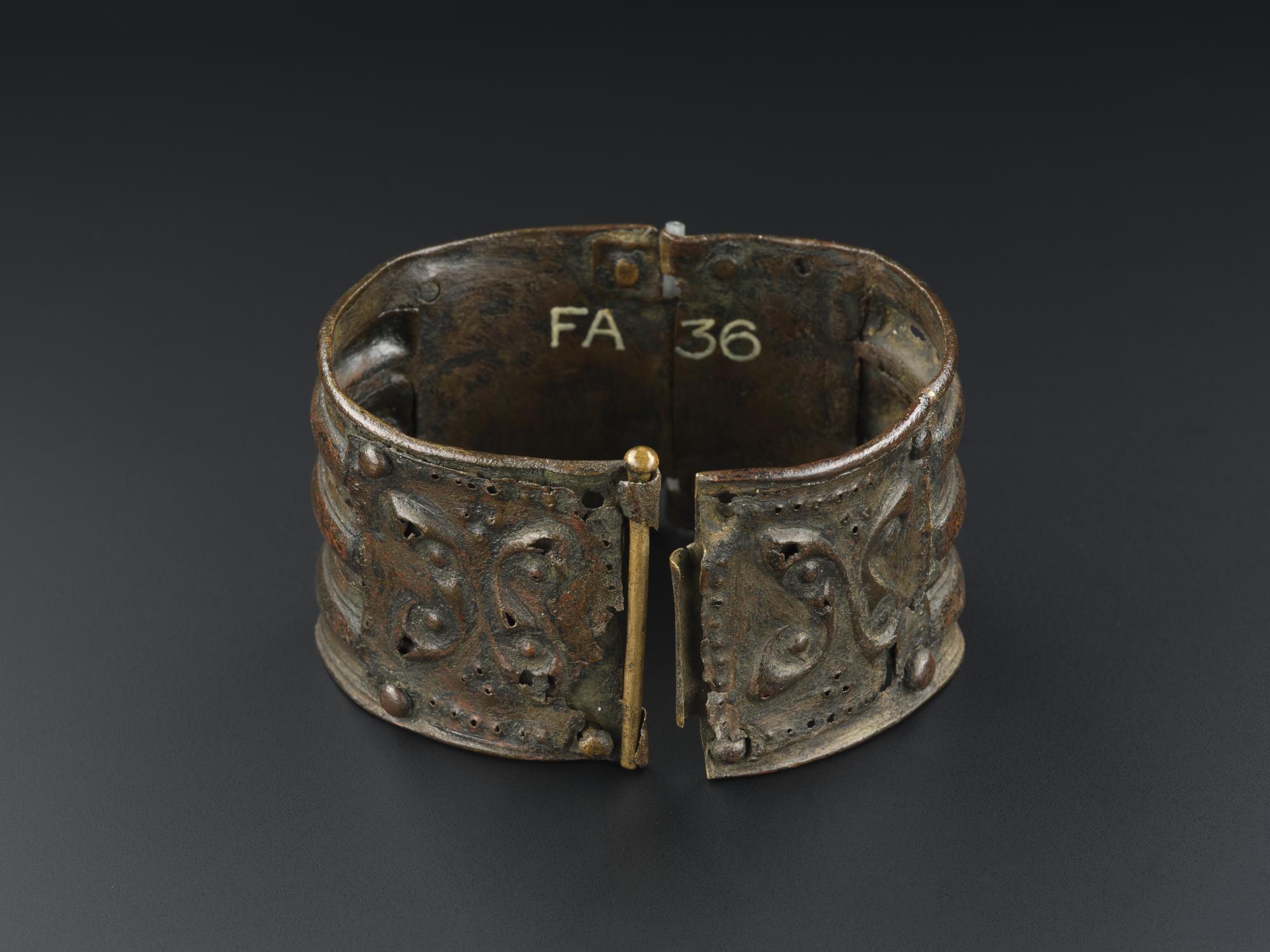 Image of Bracelet of bronze, two sections of ribbed metal hinged together, late Celtic type, found near Plunton Castle, Kirkcudbrightshire, 0 - 200 AD © National Museums Scotland