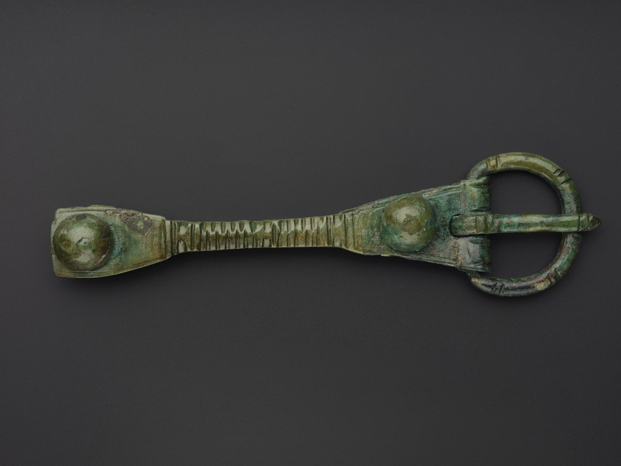 Image of Buckle of bronze, with strap and mounting, from Ardskinish, Colonsay, 875 - 925 AD © National Museums Scotland
