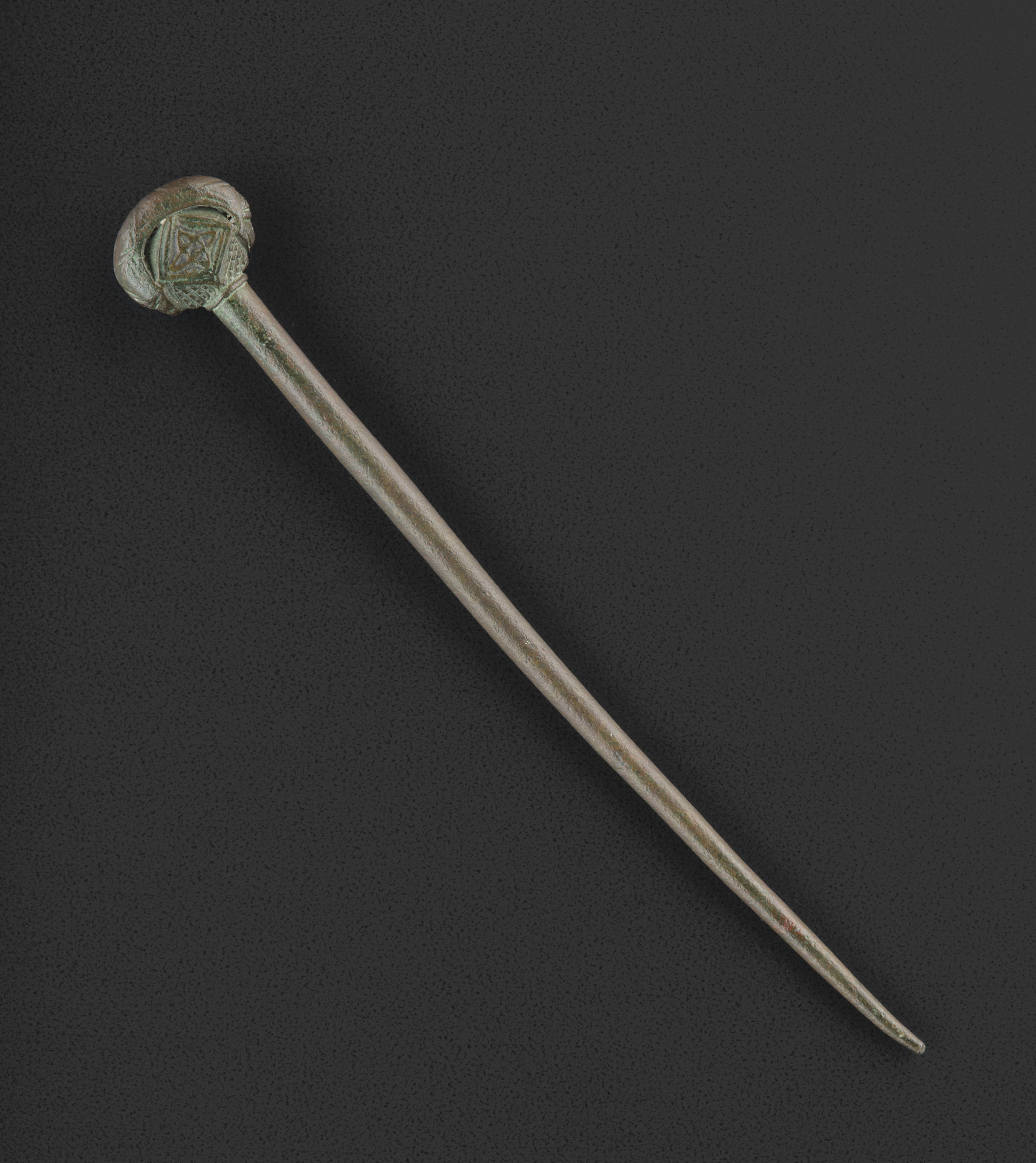 Image of Bronze kidney-shaped polyhedral-headed pin, with a band of incised chevron lines on each face, from Garvard, Colonsay, Argyll © National Museums Scotland