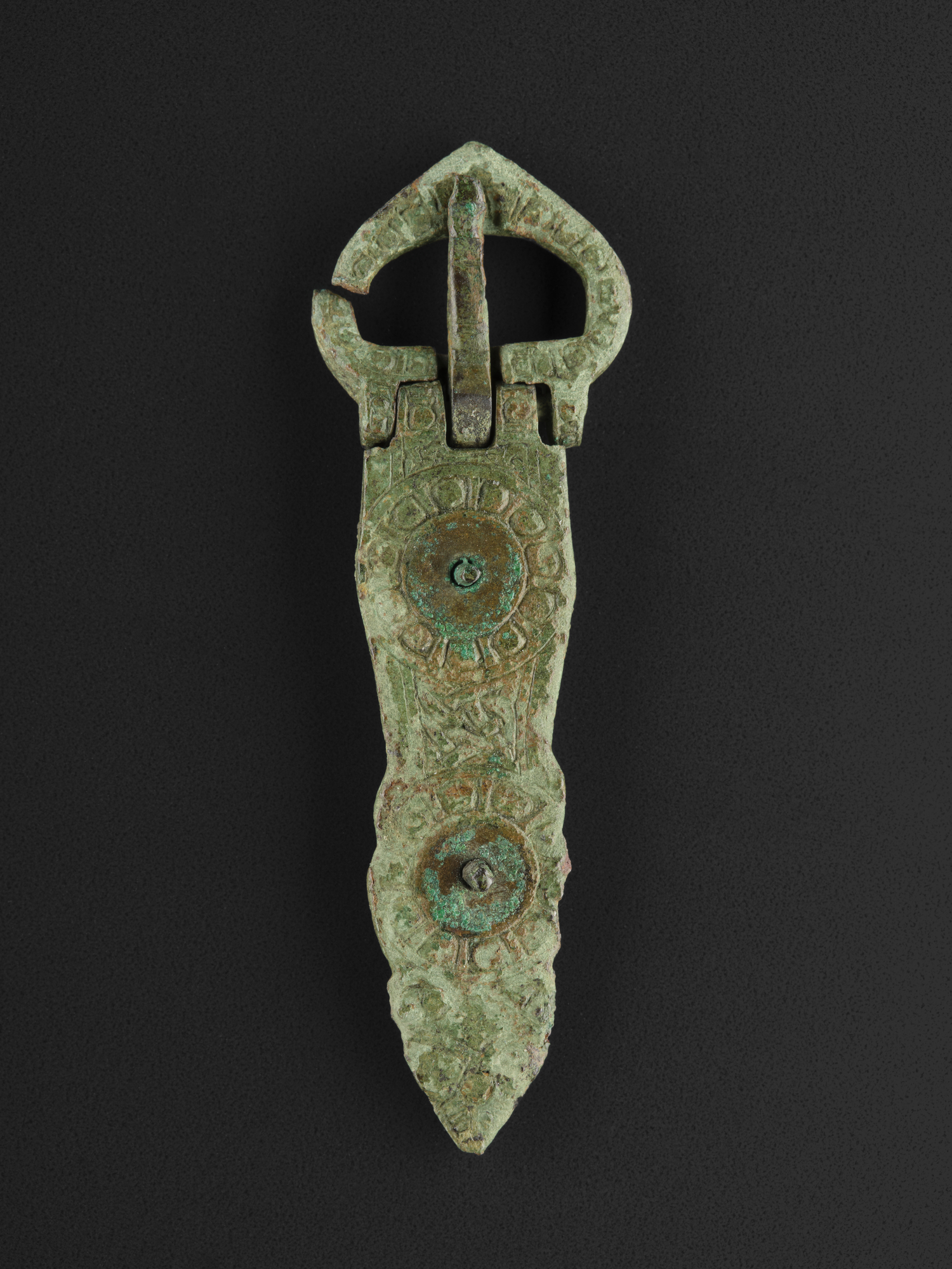 Image of Bronze buckle of ornamented circular pattern, from Kildonan, Eigg © National Museums Scotland