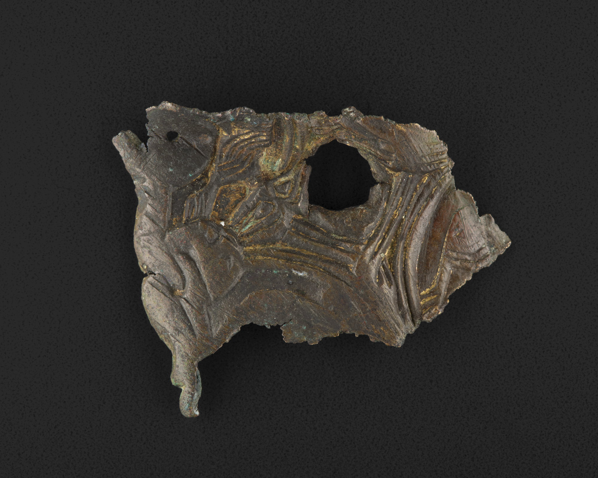 Image of Fragment of an oval brooch of cast bronze with textile imprint on reverse, from Chaipaval, Northton, Harris, 9th century © National Museums Scotland