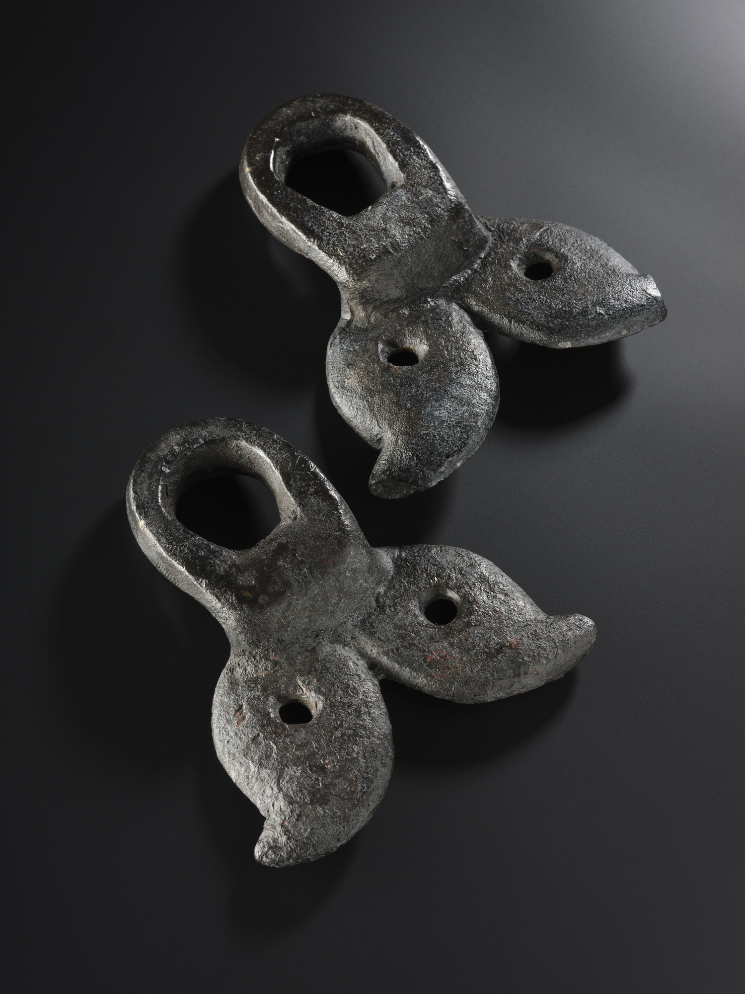 Image of One of a pair of massive loops of bronze, with fish-tailed end and perforated segments, from the Roman site at Newstead, Roxburghshire, 80 - 180 AD © National Museums Scotland