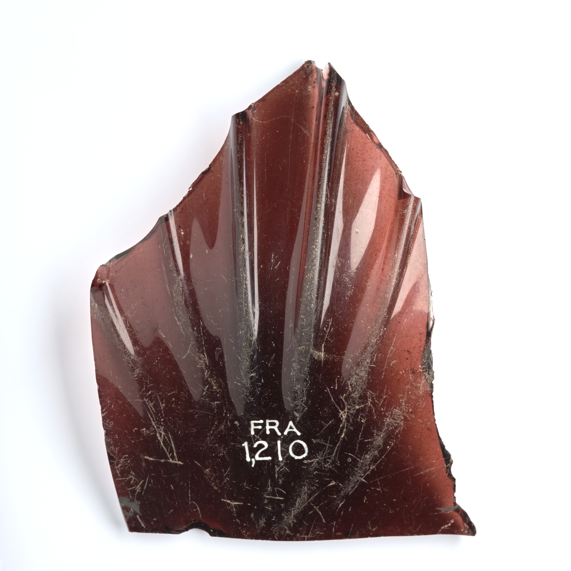 Image of Portion of vessel of wine-coloured glass with pillar moulding, from the Roman site at Newstead © National Museums Scotland