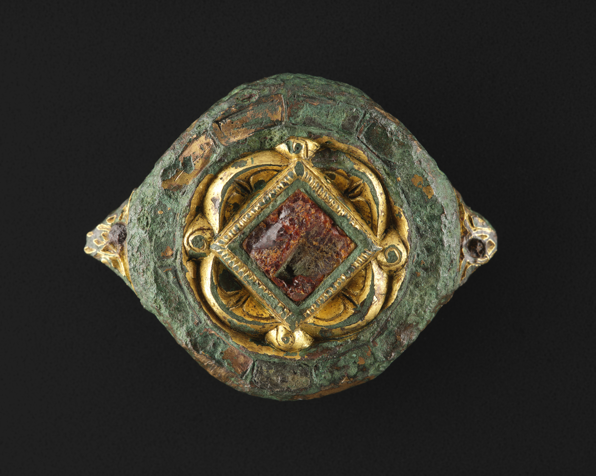 Image of Circular mount of gilt copper alloy with two triangular projections on circumference, from the west of Scotland, 800 - 1000 AD © National Museums Scotland