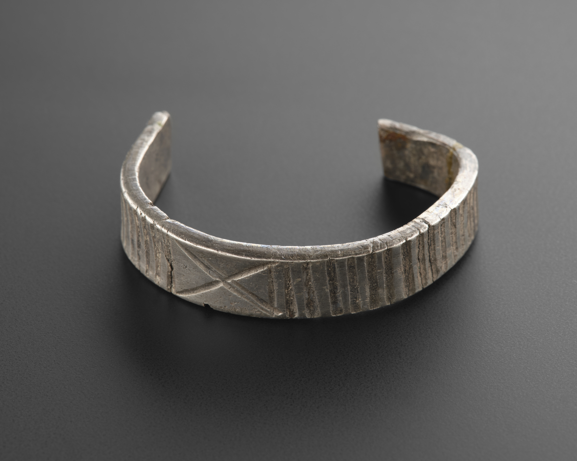 Image of Norse silver arm ring fragment, ribbed on outer side, from Blackerne, Kirkcudbrightshire © National Museums Scotland