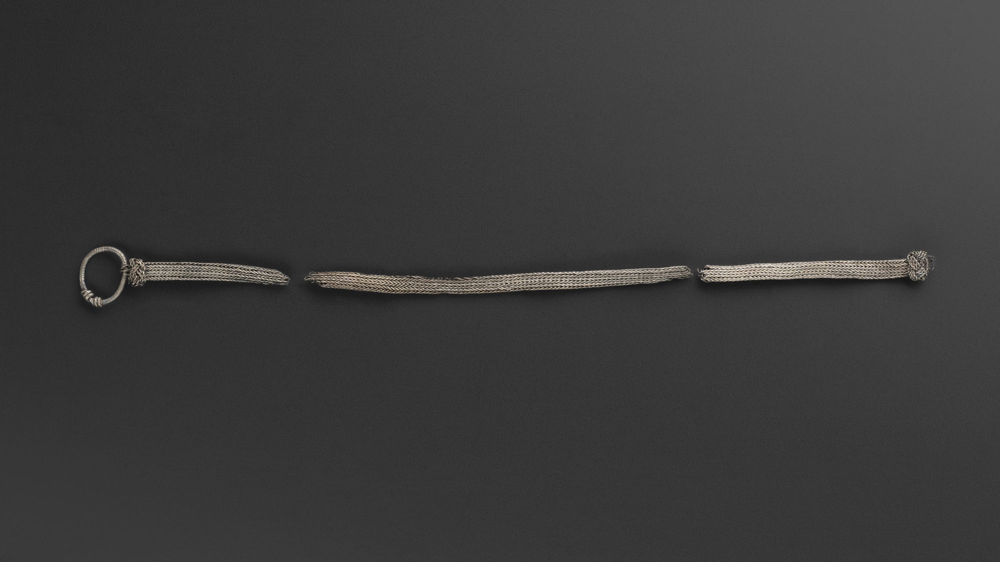 Image of Chain of fine silver wire knitted as a hollow tube, from a Viking burial at Ballinaby, Islay © National Museums Scotland