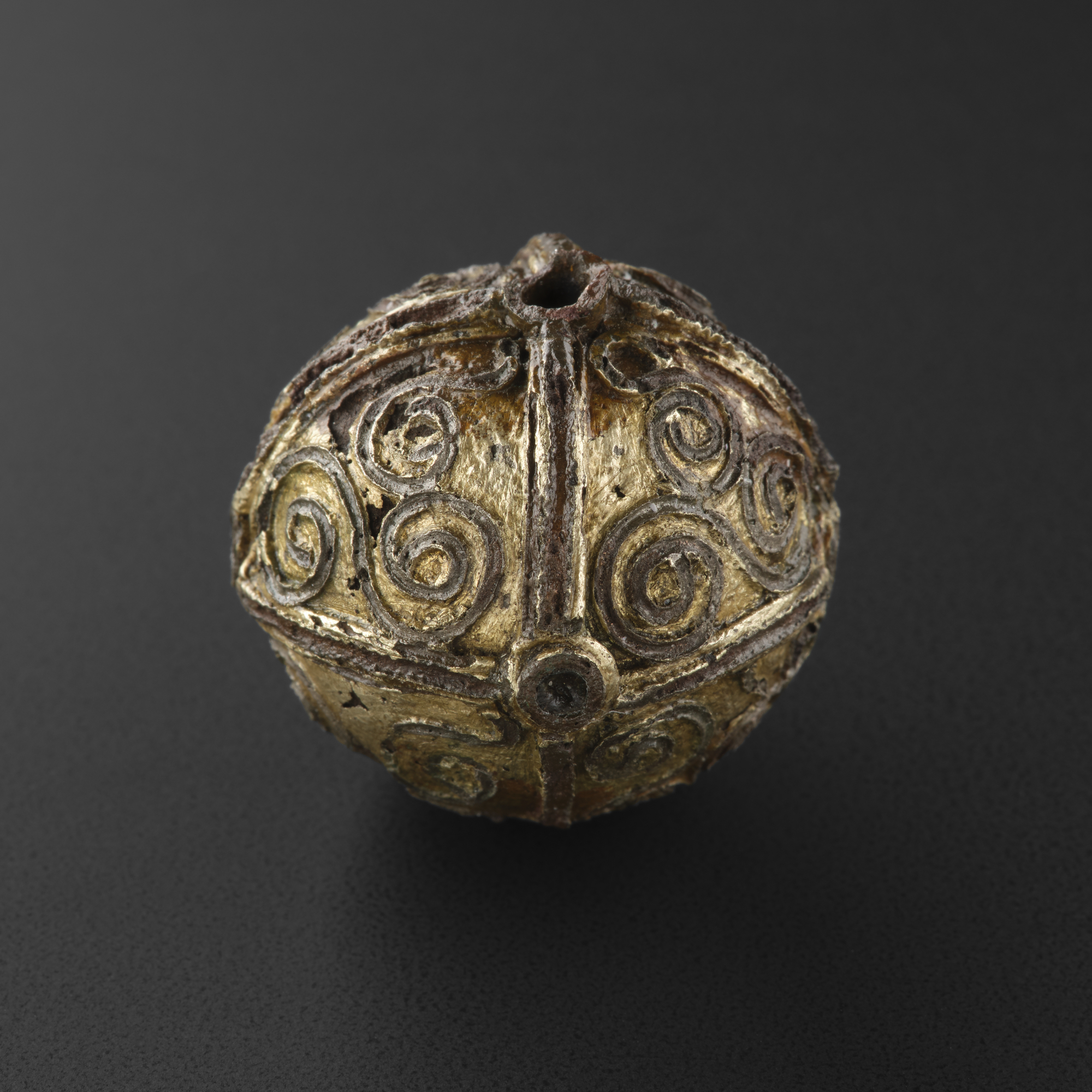 Image of Globular pinhead ornamented with quadrants filled with triquetra scrolls of filigree work, from Talnotrie © National Museums Scotland