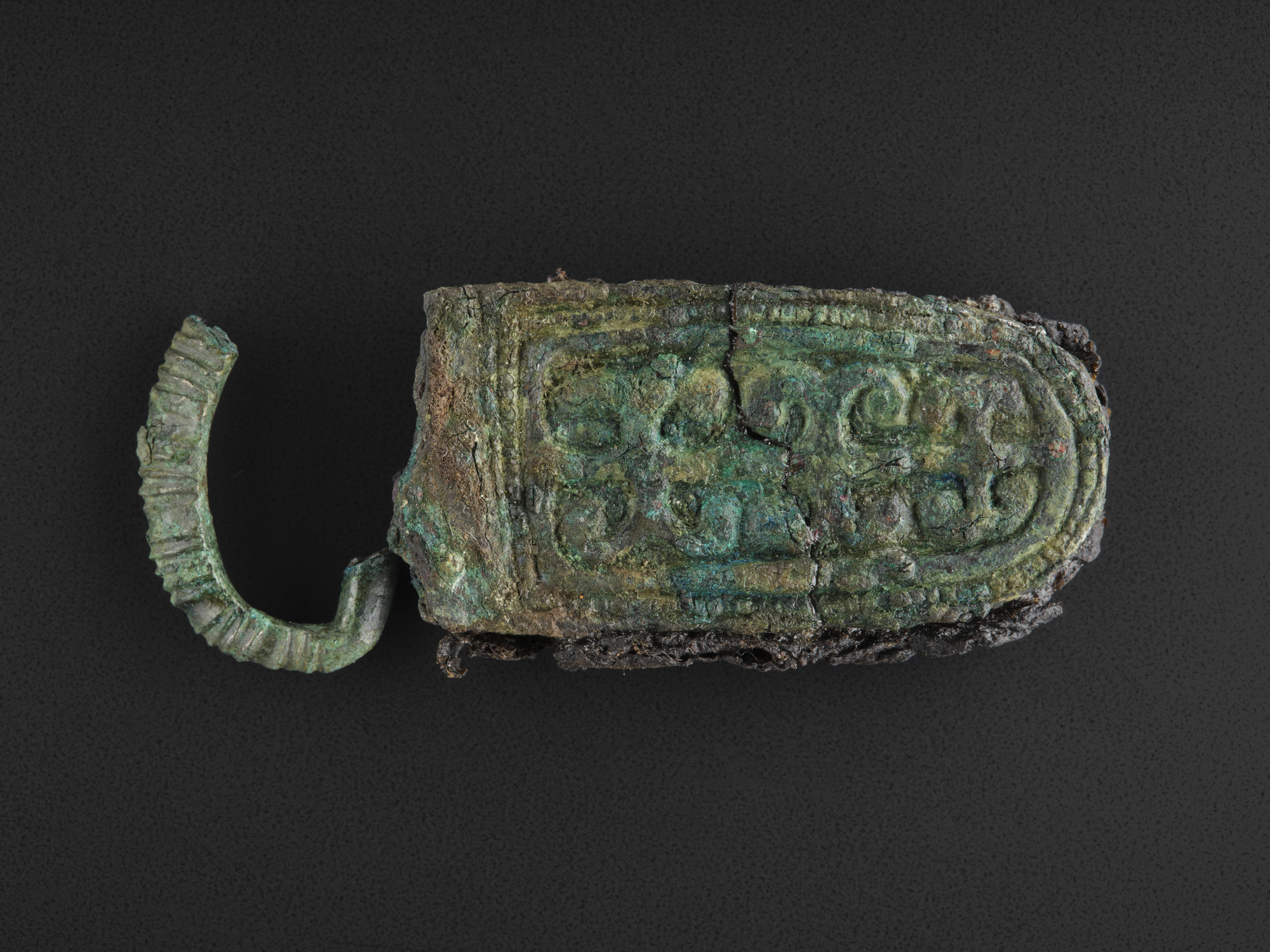 Image of Viking bronze belt clasp with scrollwork pattern, from Kildonan, Eigg © National Museums Scotland
