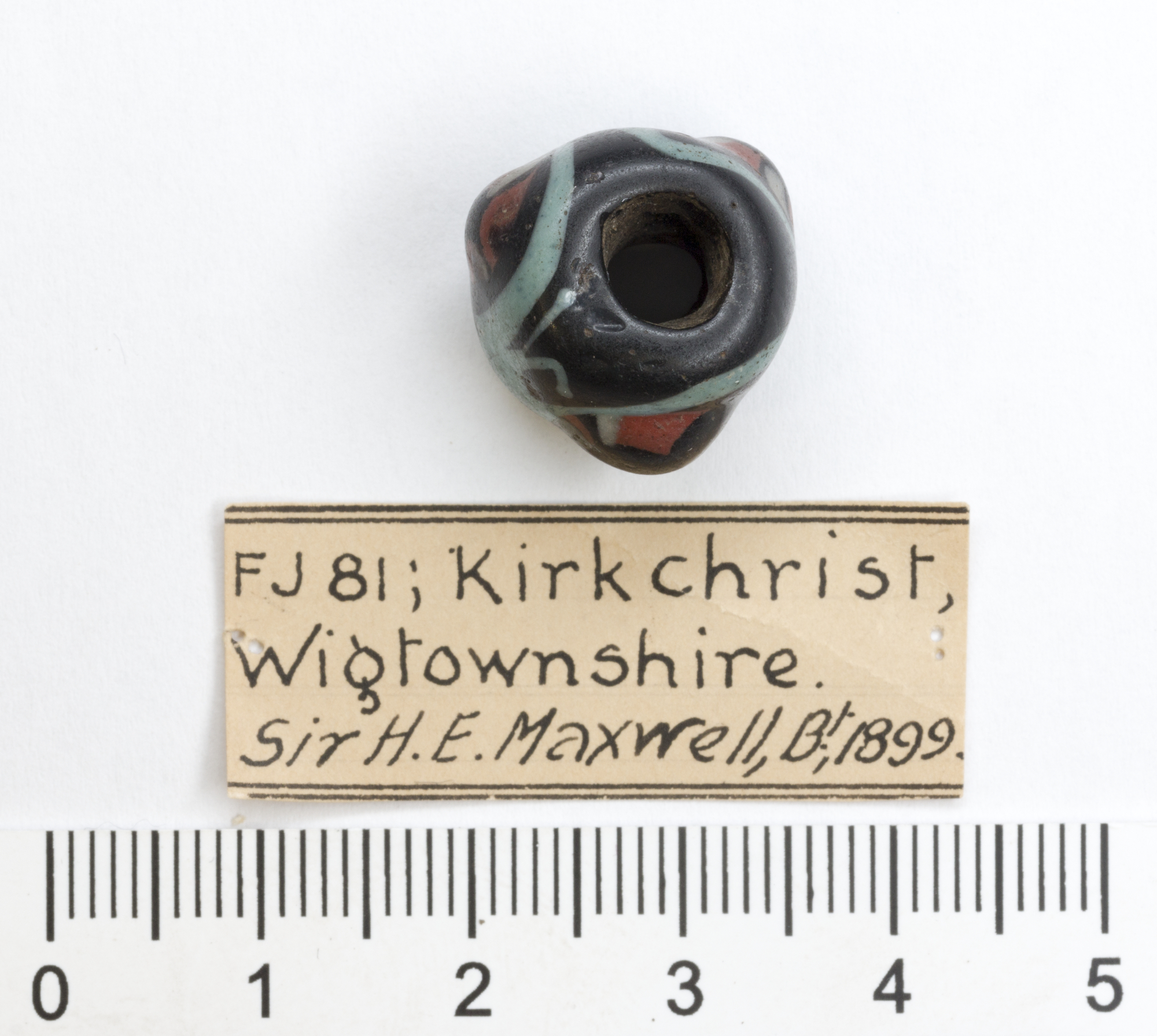 Image of Dark blue enamelled bead with pale turquoise band and three bosses vertically striped with white, red and blue, from a cairn at Kirkchrist, Wigtownshire © National Museums Scotland