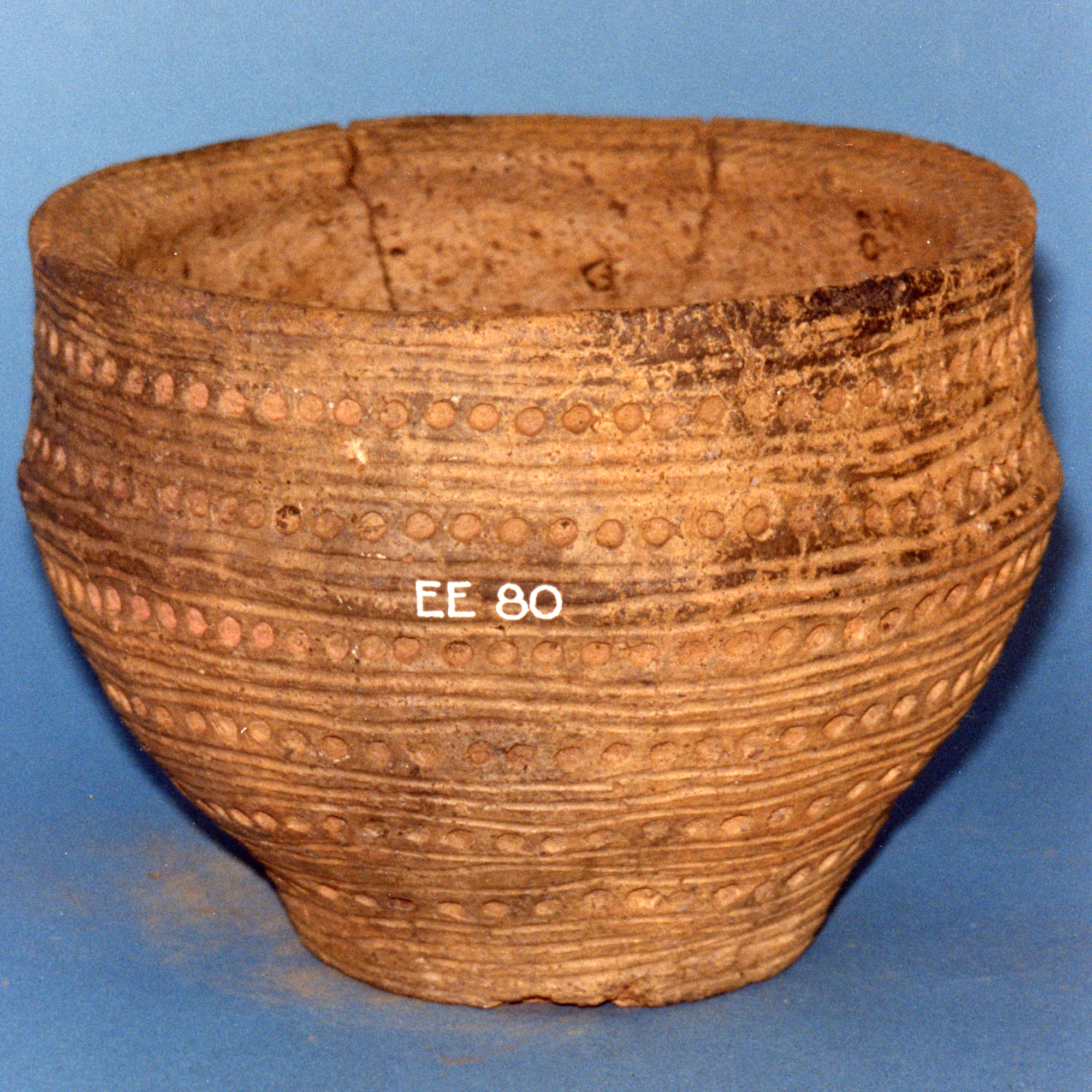 Image of Pottery food vessel with six concentric rows of circular pits and incised lines, from a cist at Duncra Hill, Pencaitland, East Lothian © National Museums Scotland