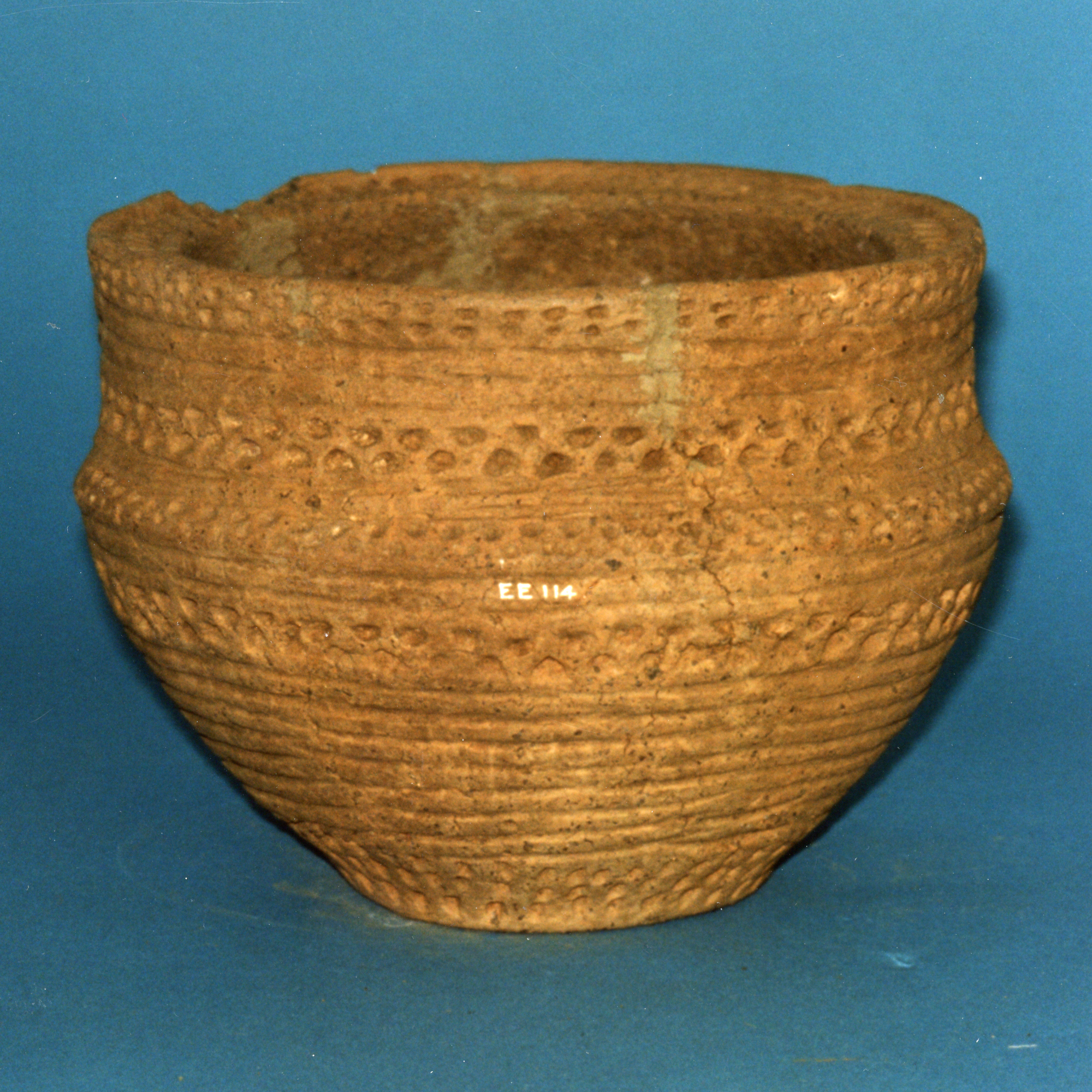 Image of Food vessel urn of brown clay decorated with lines and impressions, from Cowdenhill, West Lothian © National Museums Scotland