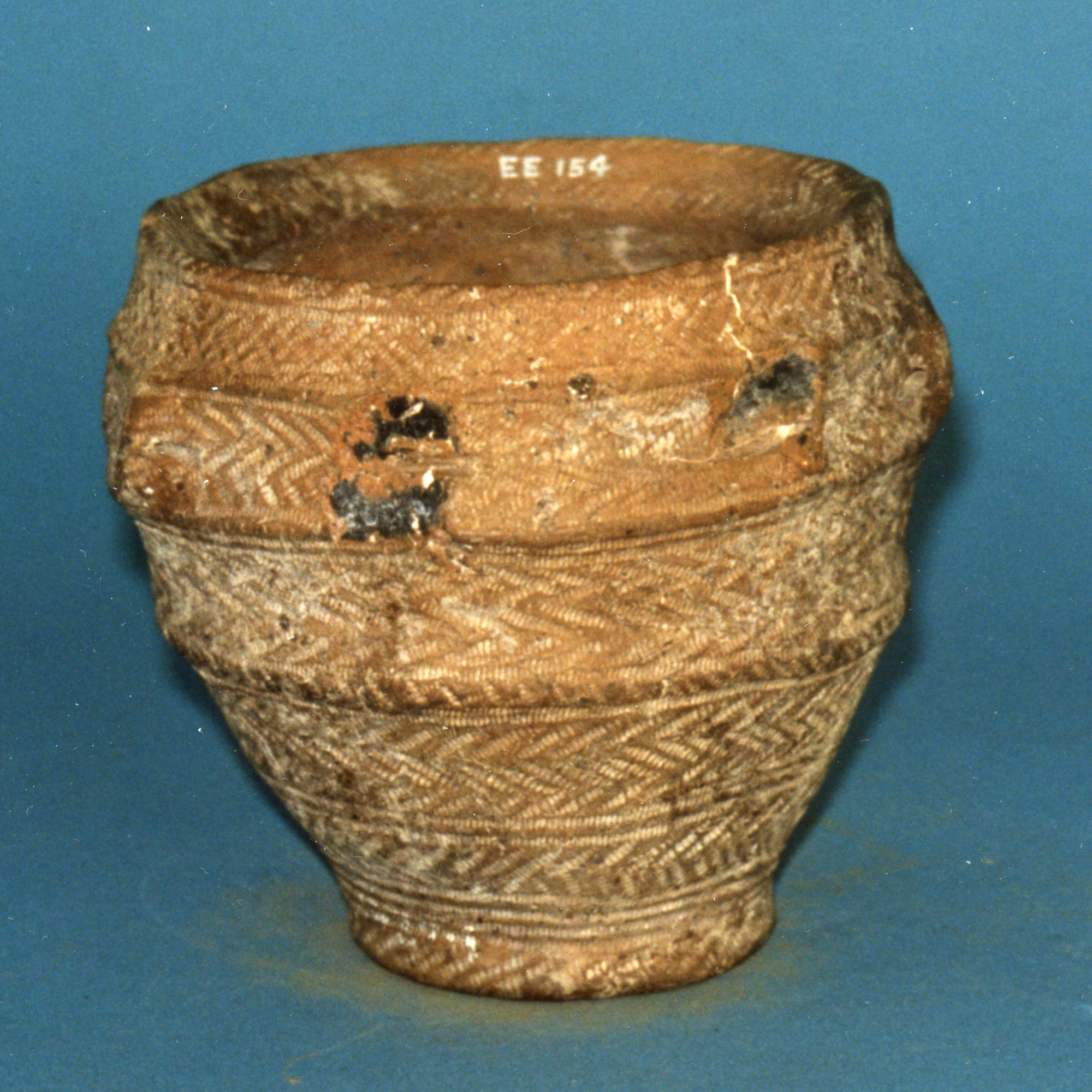 Image of Food vessel divided into four zones by horizontal mouldings, from a larger than normal luted cist at Cuninghar, Tillicoultry © National Museums Scotland