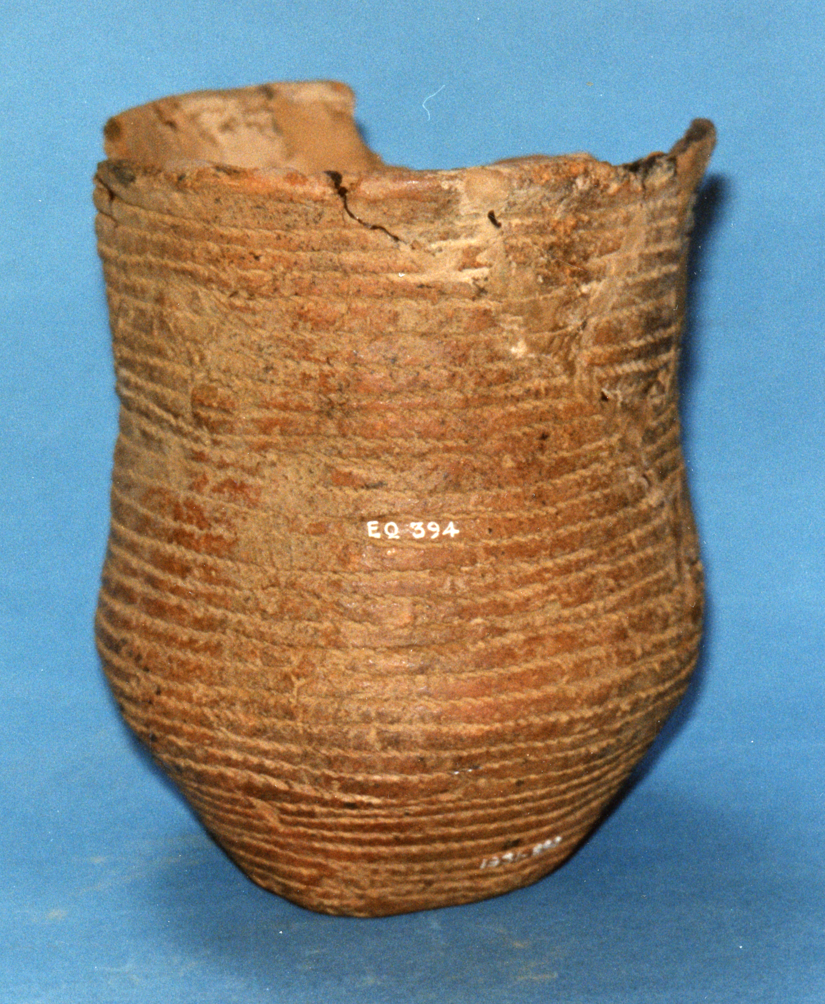 Image of Reddish-brown beaker with cord impressed decoration, from Drumelzier, Peeblesshire © National Museums Scotland