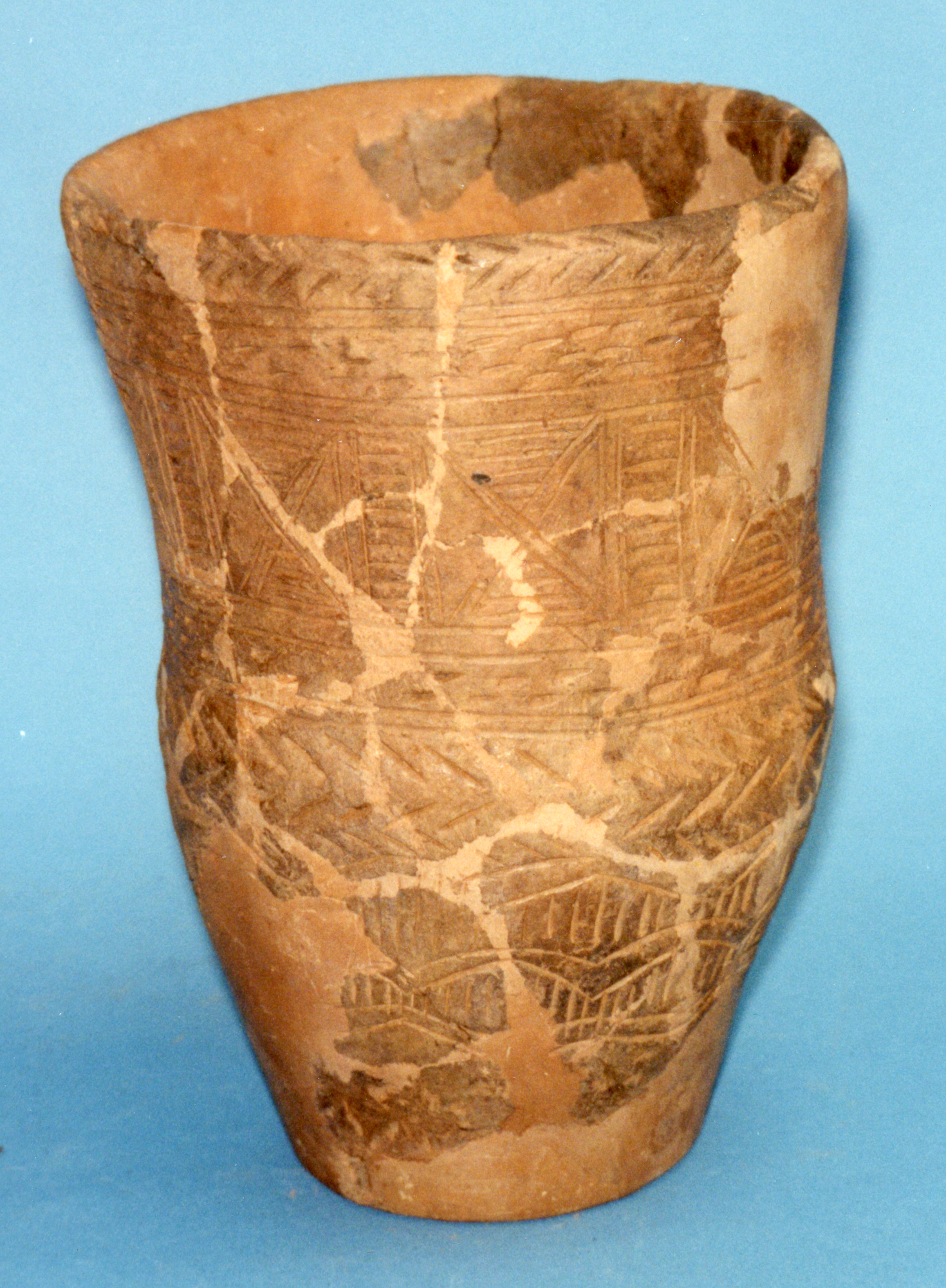 Image of Beaker with decoration mainly of incised strokes and lines arranged in horizontal zones, from a Bronze Age cremation at Limefield Farm, Lanarkshire © National Museums Scotland