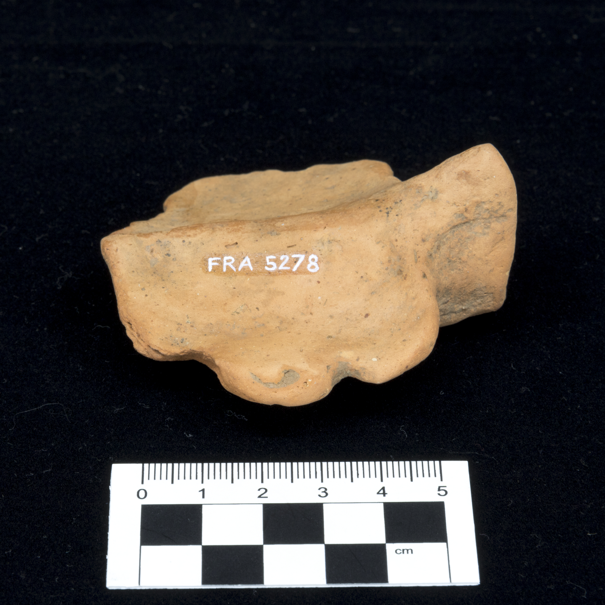 Image of Ceramic handle from an oil lamp, leaf-shaped, part of the Cruickshank collection of finds from Newstead, Roxburghshire © National Museums Scotland