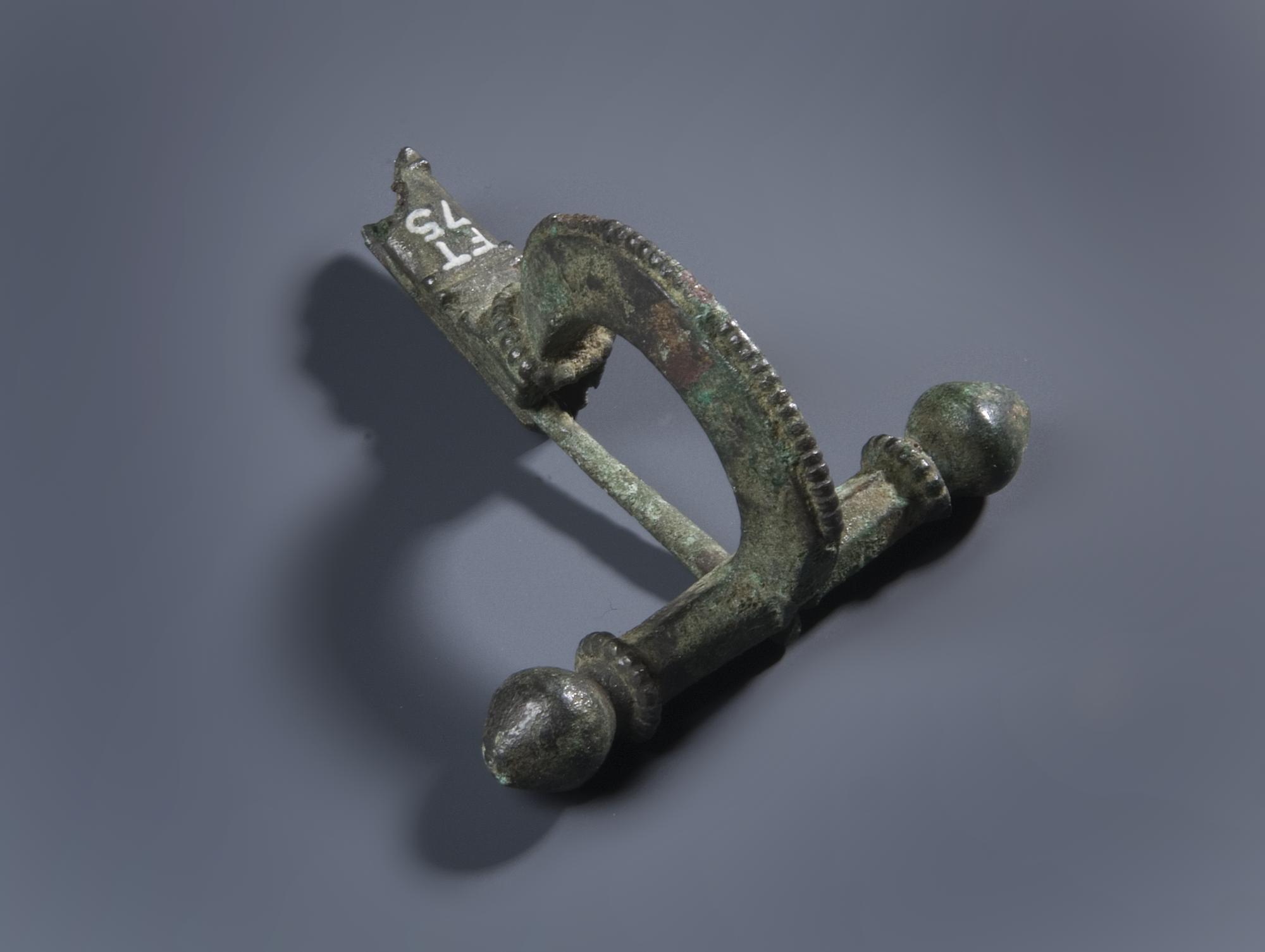 Image of Harp-shaped brooch of bronze, bow encircled by a pronounced moulding © National Museums Scotland