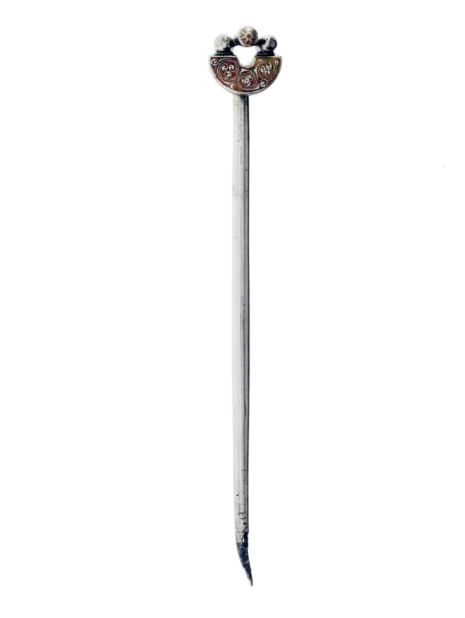 Image of Handpin of silver, with head enamelled red with spiral design, from the Pictish hoard at Gaulcross, Banffshire, 500 - 700 AD © National Museums Scotland