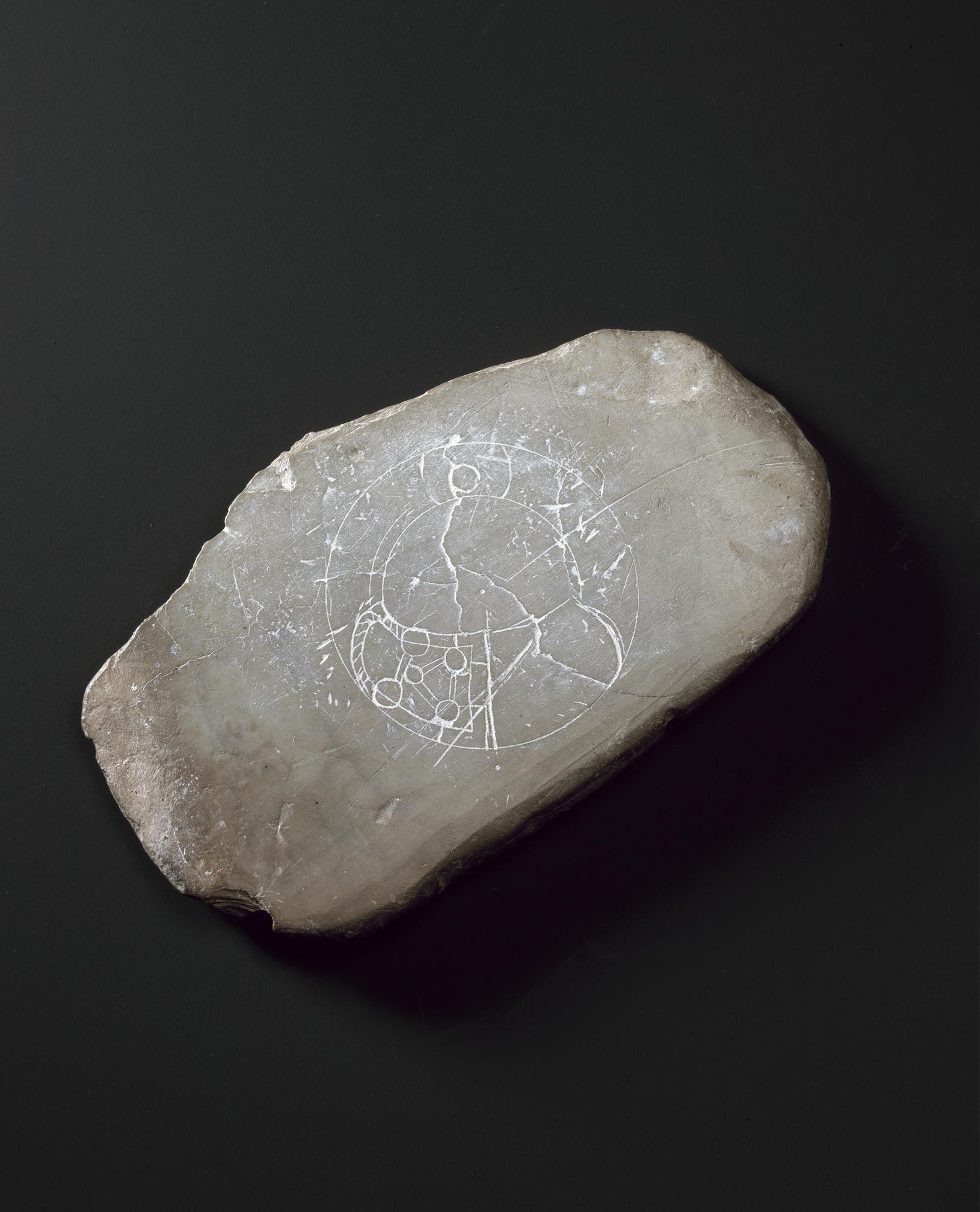 Image of Trial design on piece of slate, for a penannular brooch, from the royal hillfort at Dunadd, Argyll, 575 - 850 AD © National Museums Scotland